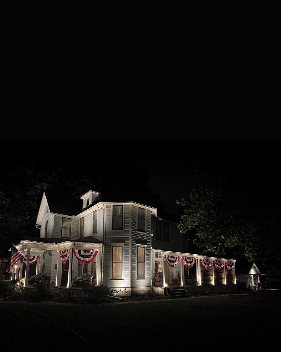 The Ruscos' Victorian lit at night — House of Rusco, Emporia KS